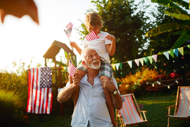 4th of july - grandfather and grandson - garden decoration stock pictures, royalty-free photos & images