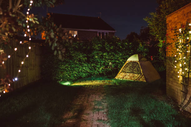 a camping tent setting in the backyard at night - garden decoration stock pictures, royalty-free photos & images