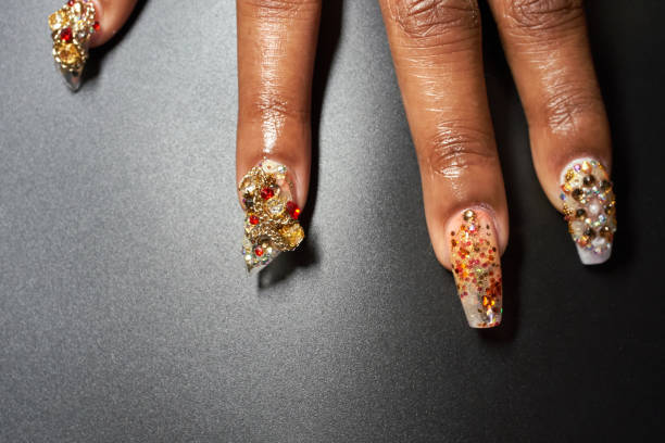 a close-up of a manicured hand and chandelier nails - nails art stock pictures, royalty-free photos & images