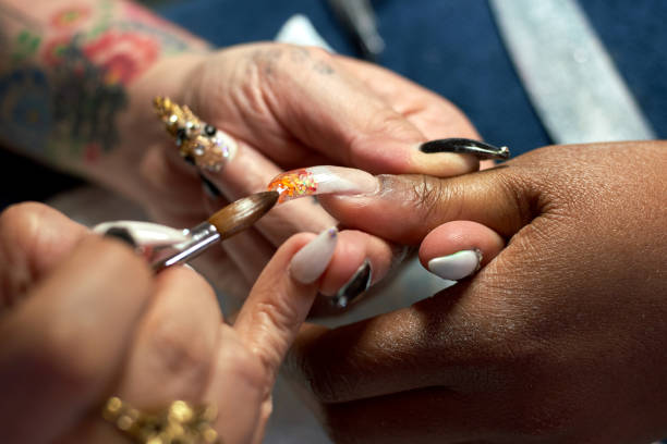 a close-up of a nail artist creating a chandelier nail manicure - nails art stock pictures, royalty-free photos & images