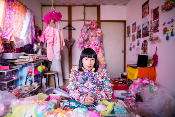 a female contemporary artist working in her studio creating art with textiles - fashion stock pictures, royalty-free photos & images