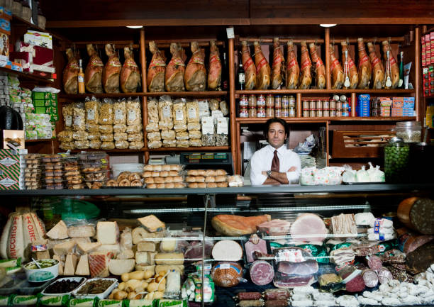 a grocer behind his counter in his shop - food stock pictures, royalty-free photos & images