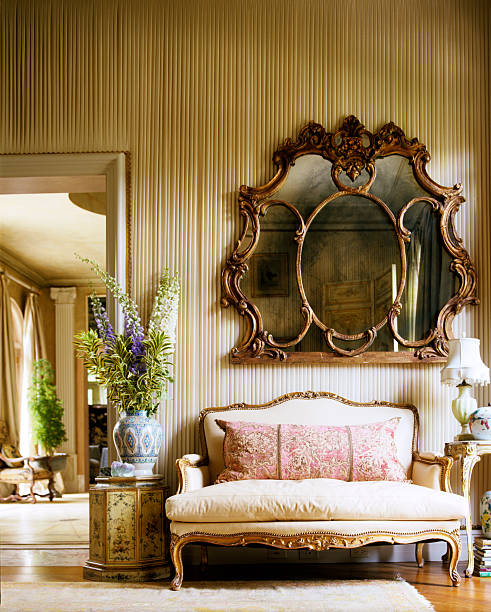 a large mirror is seen above an elegant couch in the house - home decoration stock pictures, royalty-free photos & images
