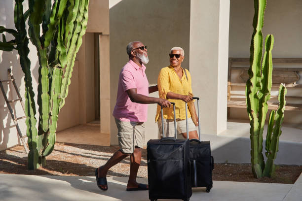 a mature couple arrive at a holiday villa - travel stock pictures, royalty-free photos & images