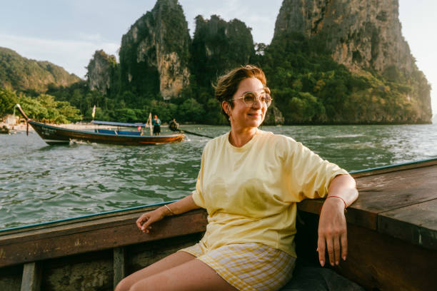 a mature woman sitting on the boat - travel stock pictures, royalty-free photos & images