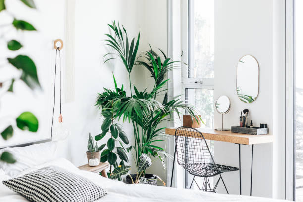 a modern, stylish and bright bedroom with plants - home decoration stock pictures, royalty-free photos & images