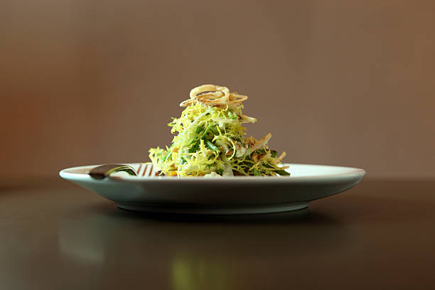 a salad garnished with fried onions - food stock pictures, royalty-free photos & images