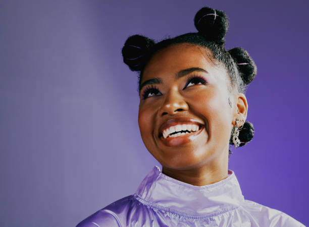 a stylish young black woman with an afro and a trendy style. portrait of an african high fashion model with a funky and retro look. a beautiful and edgy lady thinking of happy and fun times - fashion stock pictures, royalty-f