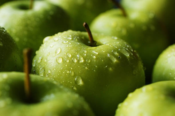 a tray full of granny smiths - food stock pictures, royalty-free photos & images