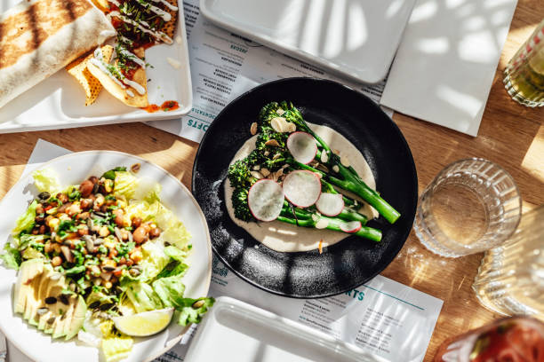 a variety of organic vegan food freshly served on the table at outdoor restaurant - food photos et images de collection