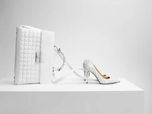 a white bag with white shoes in the form of cinderella's coach - fashion stock pictures, royalty-free photos & images