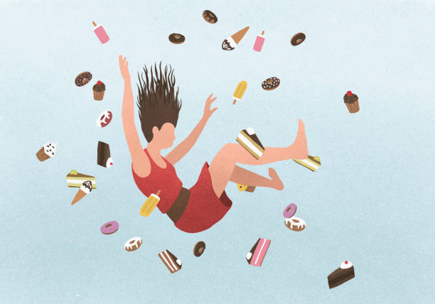 a woman falling amongst sweet junk food - junk food stock pictures, royalty-free photos & images