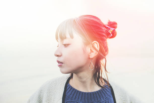 a woman looking at one point - hairstyle stock pictures, royalty-free photos & images