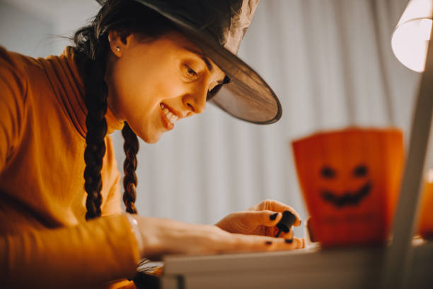 a woman paints her nails for halloween - nails art stock pictures, royalty-free photos & images