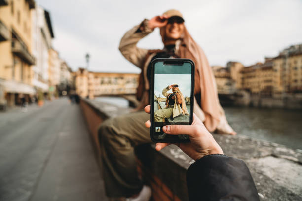 a young adult woman is taking a picture to her friends - travel stock pictures, royalty-free photos & images