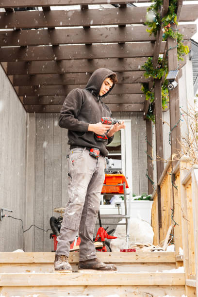 a young construction worker outside of a residential house working - home decoration stock pictures, royalty-free photos & images