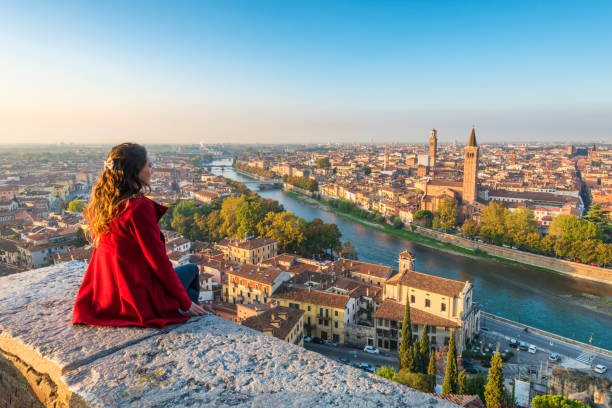 a young woman admires the view of verona old town from castel san pietro - travel stock pictures, royalty-free photos & images