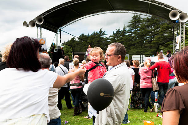 adult feeds child at the festival - concert stock pictures, royalty-free photos & images