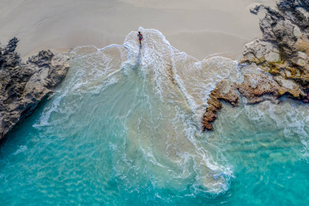 aerial view of a woman walking out of the water_little exuma_exuma_bahamas - travel photos et images de collection