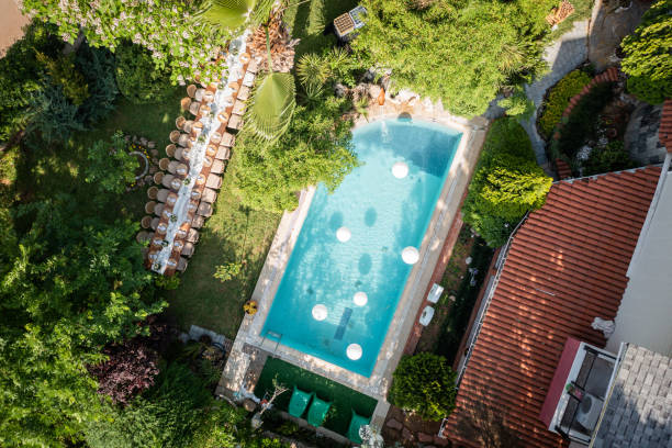 aerial view of wedding reception and large dining table in garden of modern house with poolside lounge - garden decoration stock pictures, royalty-free photos & images