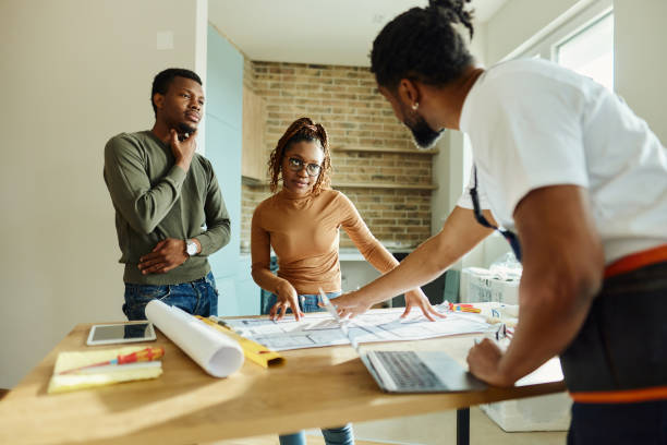 african american couple talking to manual worker during renovation process. - home decoration stock pictures, royalty-free photos & images