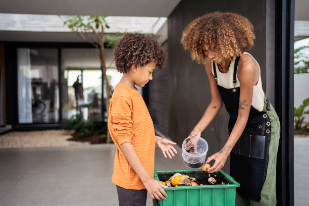 african american young woman and her younger brother making compost from leftovers. sustainability concept. - food stock pictures, royalty-free photos & images
