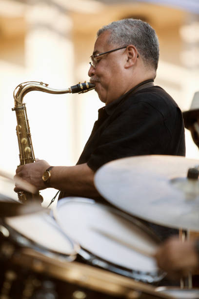 afro-columbian man playing saxophone - concert stock pictures, royalty-free photos & images