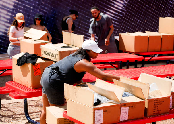 Alicia Fairchild, bottom, helps unbox and unload Beyoncé merchandise before the artists two weekend concerts at NRG Stadium, Saturday, Sept. 23 in...