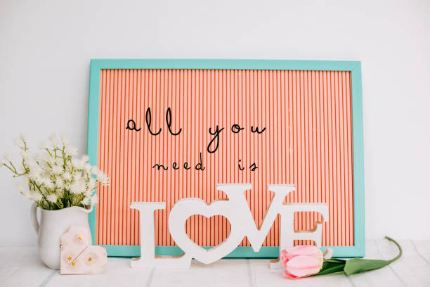 all you need is love text neon text in mockup - home decoration stock pictures, royalty-free photos & images