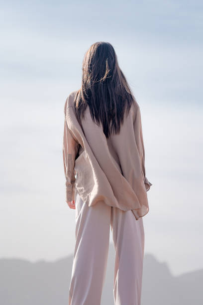 alone girl contemplating the horizon that opens in front of her - fashion stock pictures, royalty-free photos & images