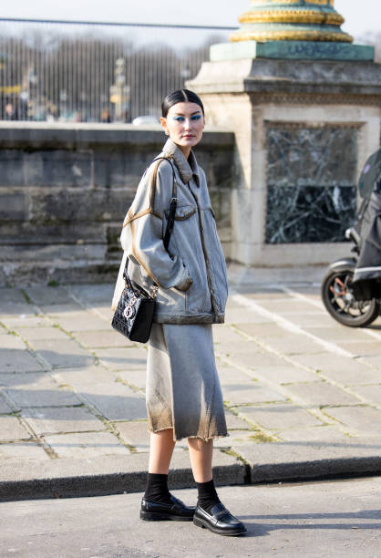 Amalie Gassmann wears grey oversized jacket, skirt, black bag outside Dior during the Womenswear Fall/Winter 2024/2025 as part of Paris Fashion Week...