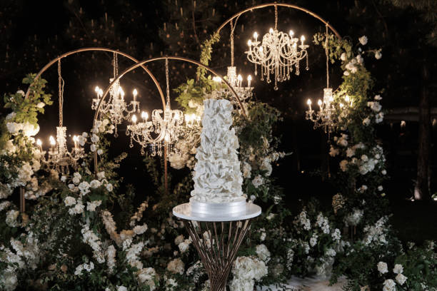 amazing wedding cake in the evening illumination - garden decoration stock pictures, royalty-free photos & images