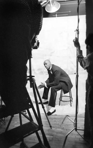 American basketball player Micheal Jordan sits on a stool as he poses, modeling samples from a line of formalwear, during a photo shoot, Chicago,...