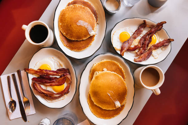 american breakfast at the diner with fried eggs, bacon and pancakes - food stock pictures, royalty-free photos & images