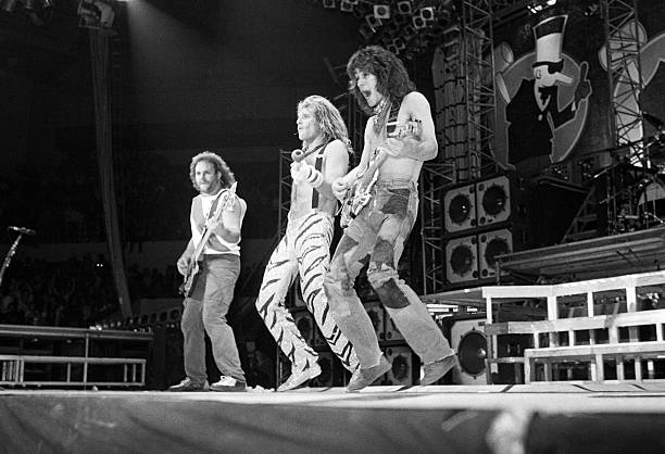 American musicians David Lee Roth, Eddie Van Halen, and Michael Anthony, of the group Van Halen, perform at Nassau Coliseum, Uniondale, New York,...