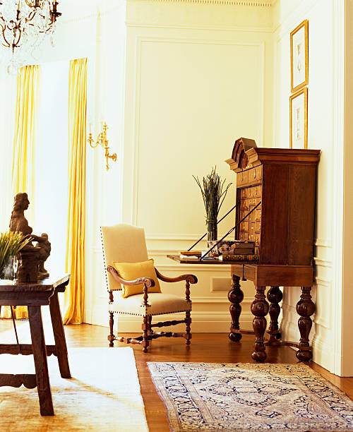 an armchair is kept beside a wooden cabinet in a house - home decoration stock pictures, royalty-free photos & images