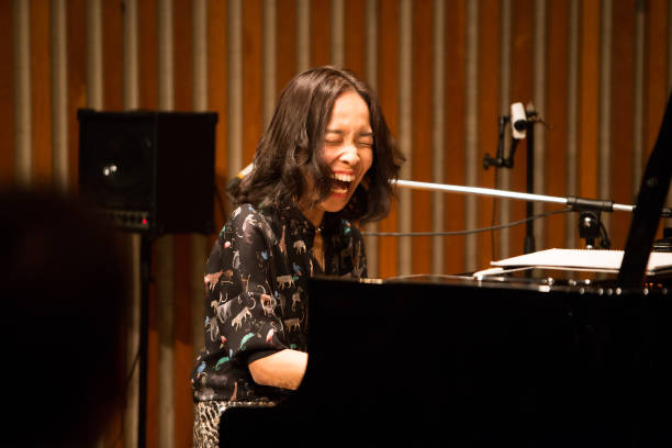 an artist playing the piano while laughing - concert stock pictures, royalty-free photos & images