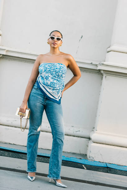 An attendee wears a Once Was scarf, Good American jeans and Dior bag at Melbourne Fashion Festival 2024 on March 07, 2024 in Melbourne, Australia.