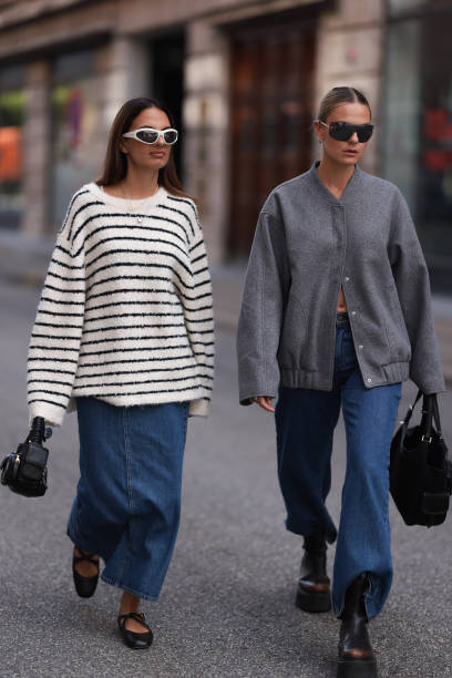 Anna Winter seen wearing white sunglasses, gold and silver necklaces, Edited white and black striped oversized boucle sweater, Edited blue denim long...