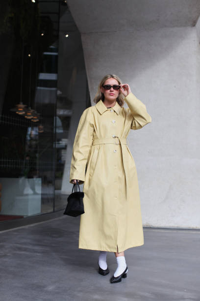 Annie Wheatland-Clinch is seen wearing a pastel yellow leather trench coat outside the Roksanda show during London Fashion Week February 2025 on...