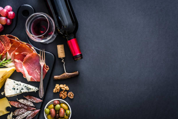 appetizer frame: red wine, iberico ham and cheese on rustic table - food stock pictures, royalty-free photos & images