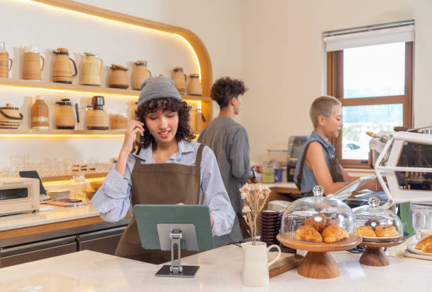 asian barista taking online order from customer - junk food stock pictures, royalty-free photos & images