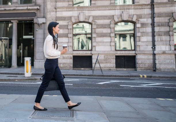 asian business woman walking on the street drinking a cup of coffee - junk food stock pictures, royalty-free photos & images