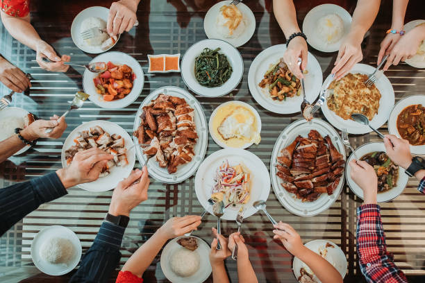 asian chinese family enjoy their home made food during chinese new year's eve reunion dinner - food stock pictures, royalty-free photos & images