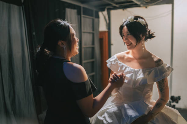 asian chinese female emcee handshake congratulating success performance of female opera singer at backstage after performance show - concert stock pictures, royalty-free photos & images