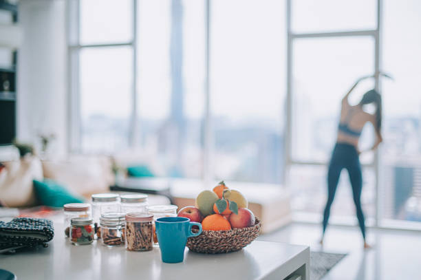 asian chinese female home workout in domestic living room facing the city - food stock pictures, royalty-free photos & images