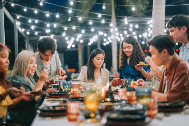 asian chinese lesbian couple celebrating birthday outdoor dining with friends - food stock pictures, royalty-free photos & images
