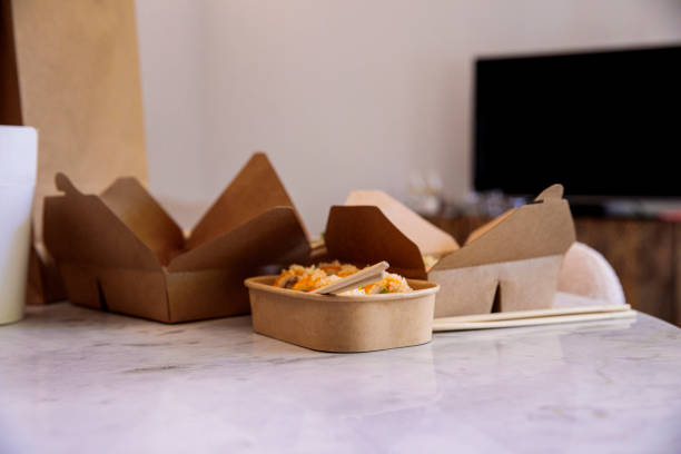 asian food in eco friendly paper packaging boxes on a table - junk food stock pictures, royalty-free photos & images