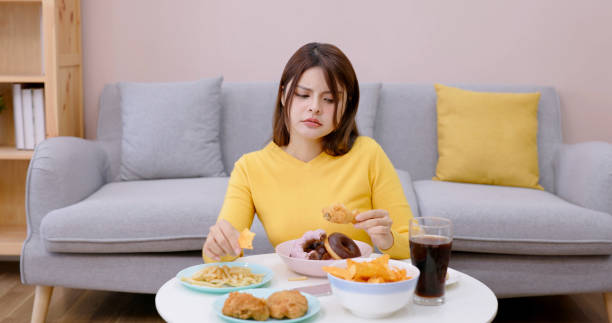 asian girl overeating - junk food stock pictures, royalty-free photos & images