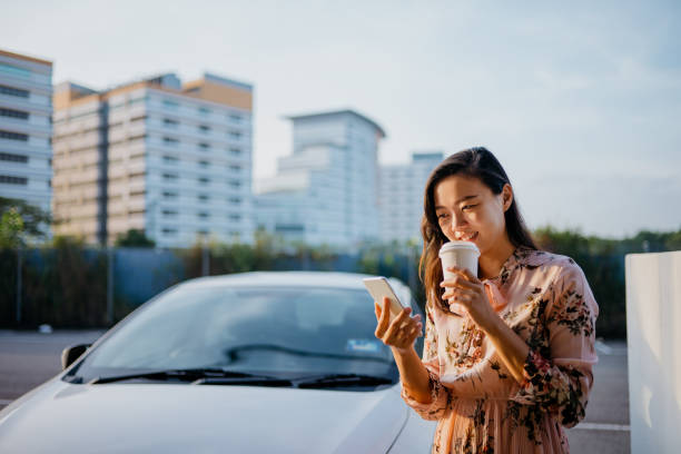 asian woman using phone and drinking coffee in the morning - junk food stock pictures, royalty-free photos & images